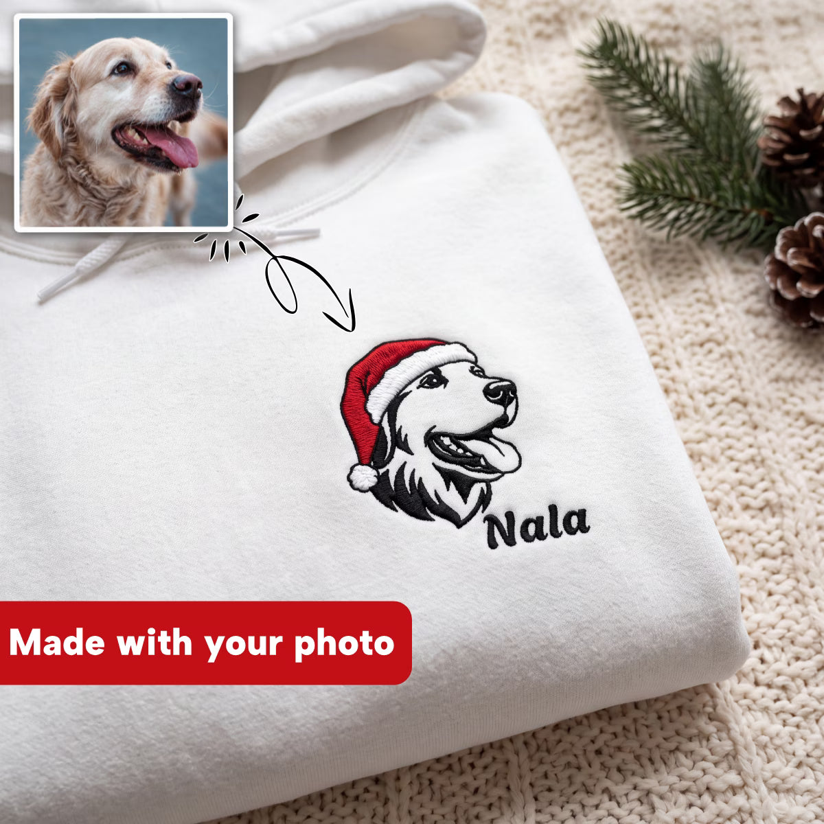 A folded white hoodie on a knitted beige surface with a printed dog portrait wearing a red Santa hat and the name 'Nala' below it. A small inset photo of a golden retriever appears in the top left, with an arrow pointing to the hoodie design and a red banner reading 'Made with your photo.
